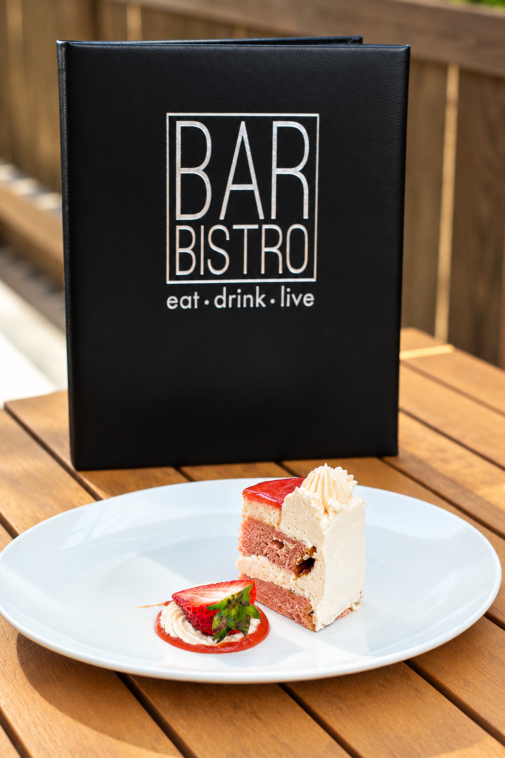 Strawberry cake in front of the Bar Bistro menu