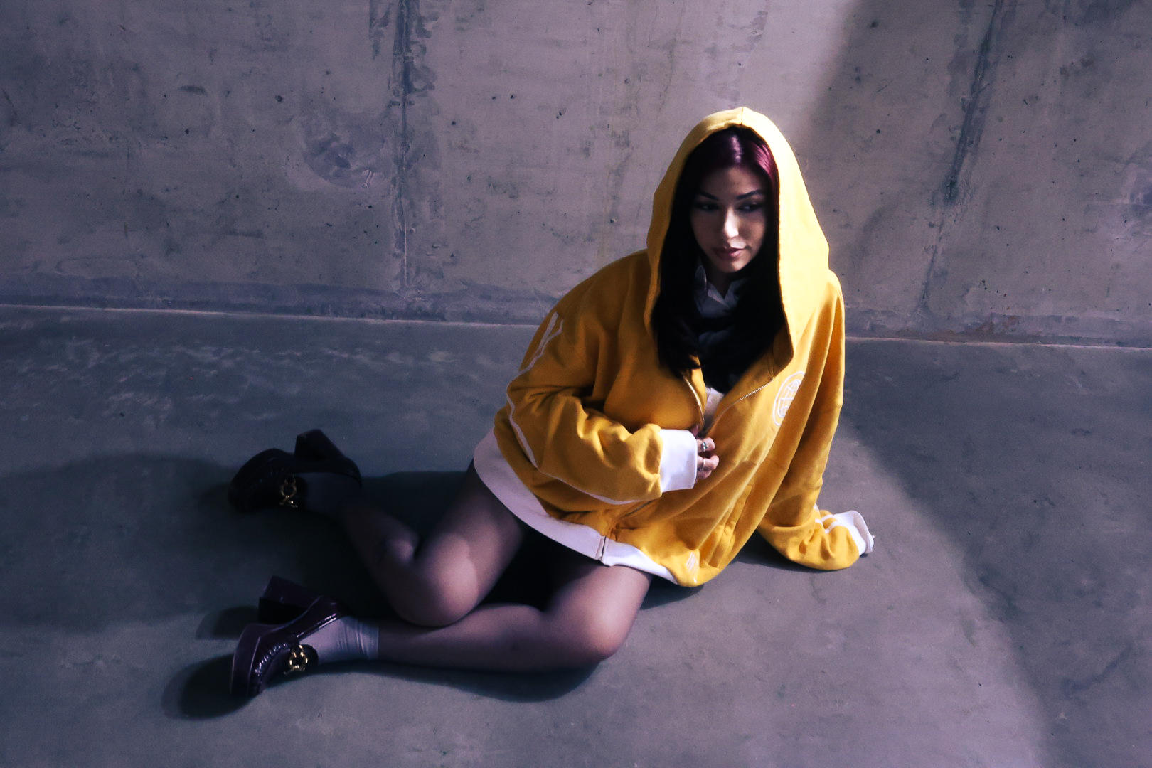 Yellow hoodie, concrete room